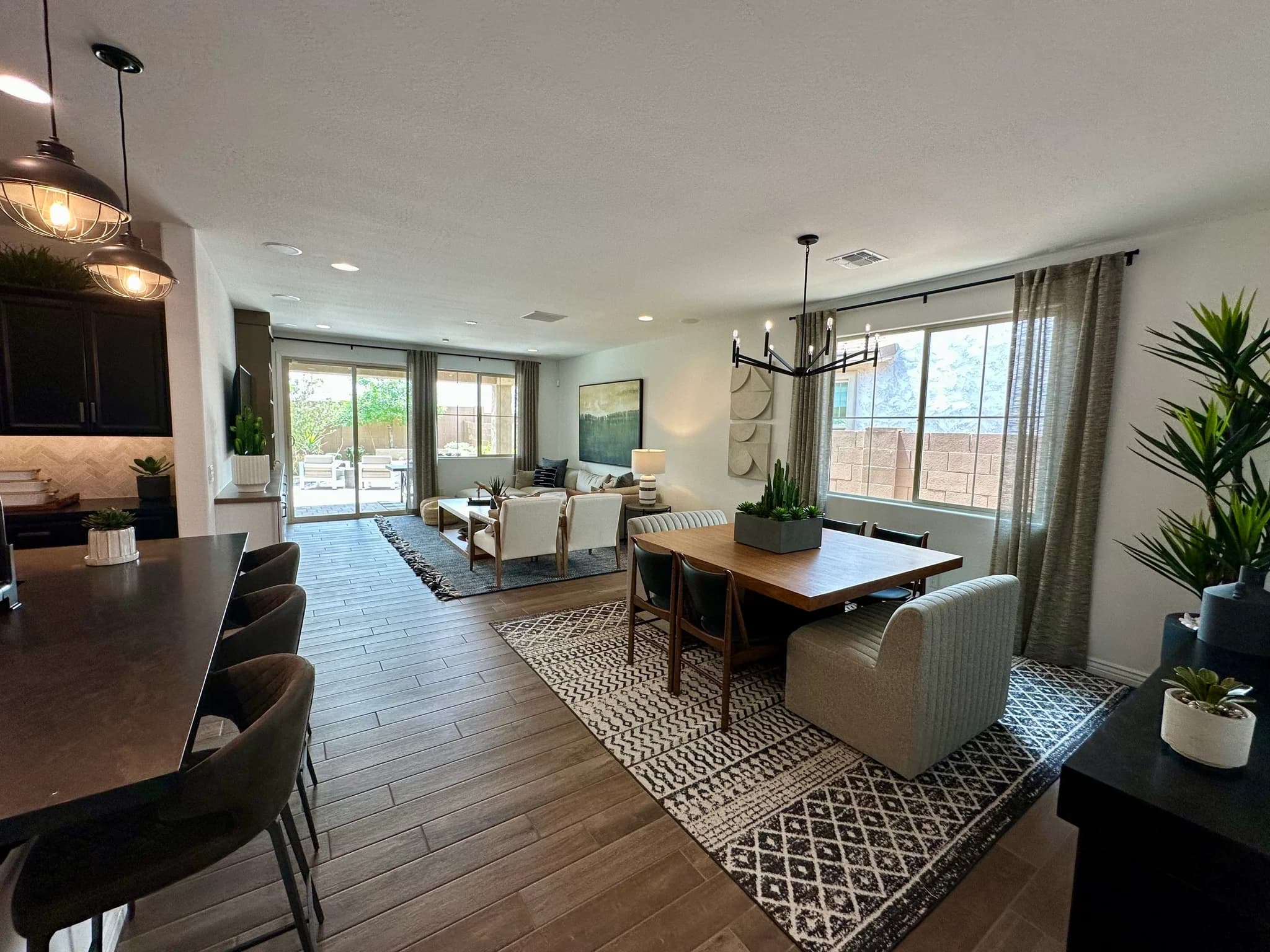 Model home great room with a marble island and backyard view