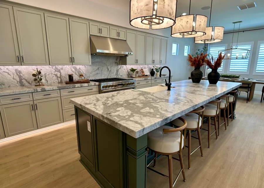 Model home kitchen with marble island and pendant lights